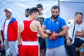 Coach puts on the gloves to the boxer during Boxing match between national teamsÃÂ UKRAINE - ARMENIA